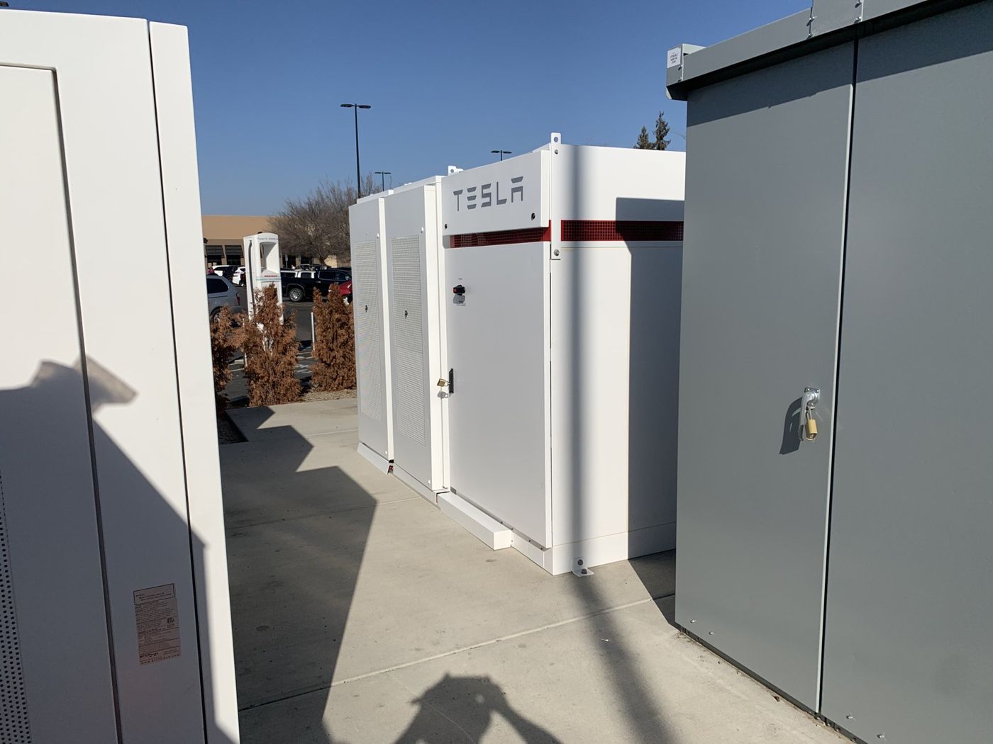 Battery storage cabinets installed beside electrical gear at a charging site