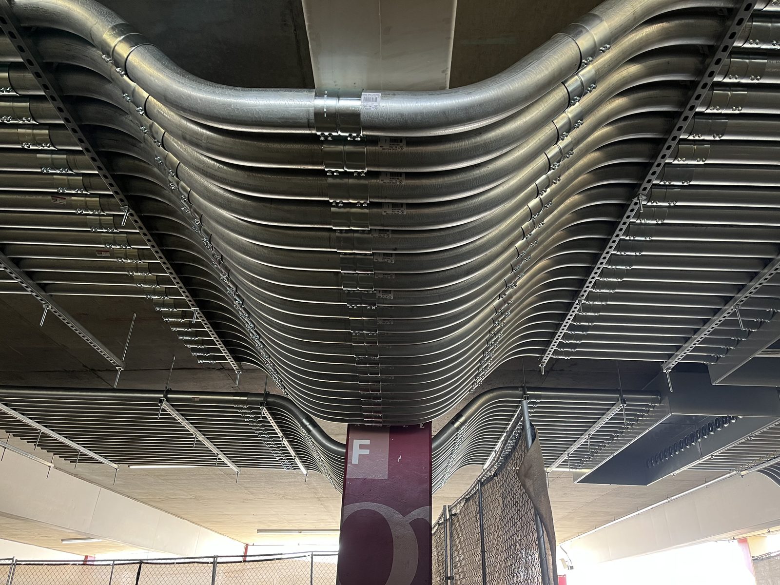 Parallel EMT conduit rack sweeping around a column