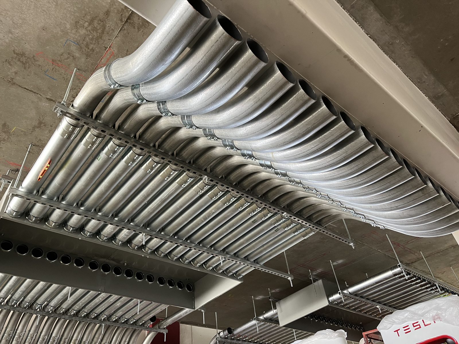Concentric conduit bends on a strut rack