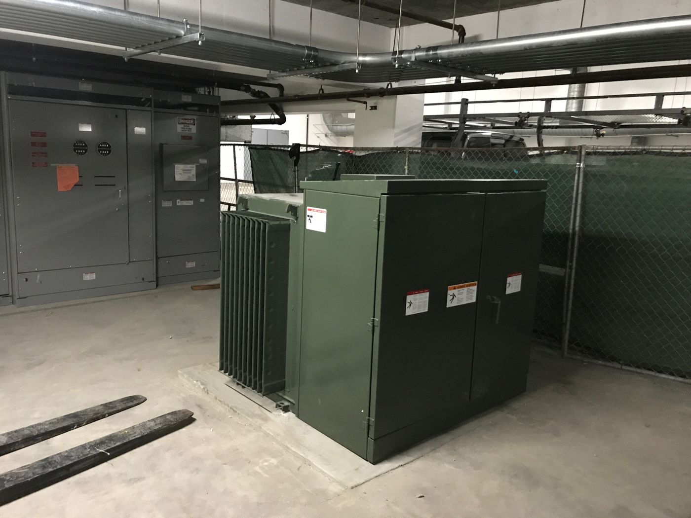 Transformer set in a parking structure next to the main switchgear